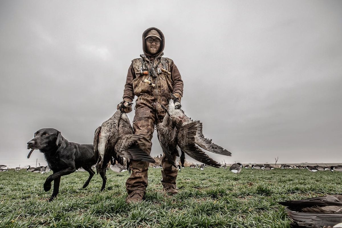 Hunter and dog with a morning's pile of birds