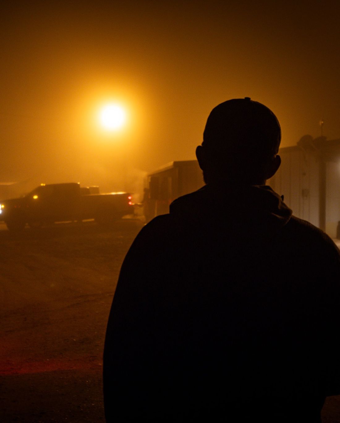 Pre-dawn at the Big Honker Lodge — hunter silhouette in the lodge yard